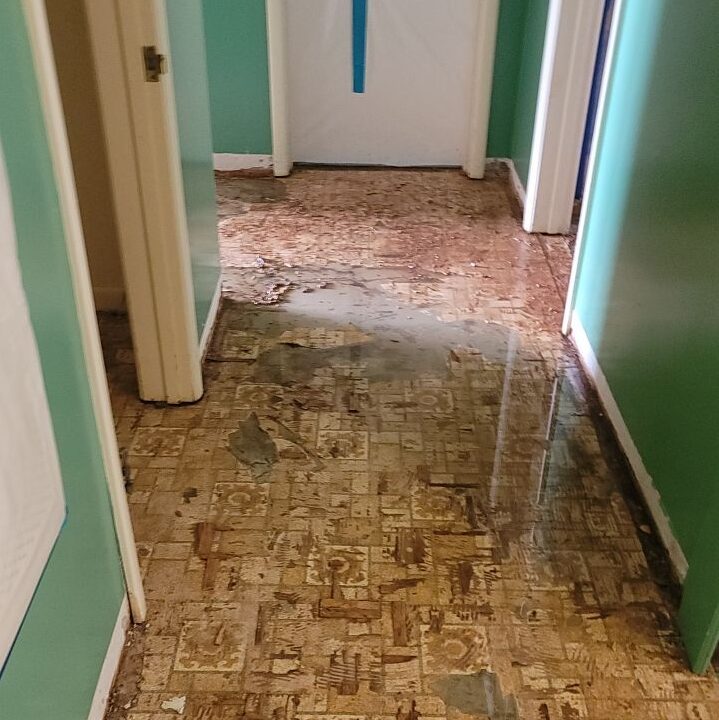 an asbestos tile floor being removed from house